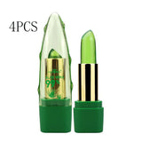 Green lip balm with gold cap on a white background