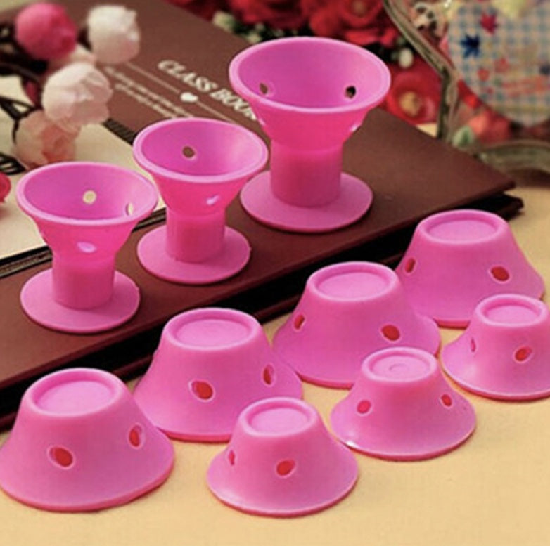 Pink silicone cups with suction cups on a brown surface