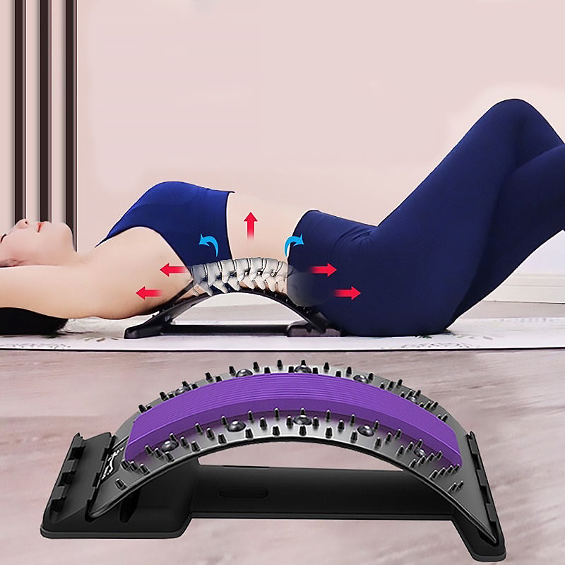 Person using a purple and black exercise device on a wooden floor.