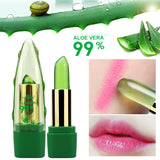 Green aloe vera lipstick with aloe vera leaves and droplets on a white background