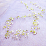 Delicate gold and pearl hair vine on a light purple background