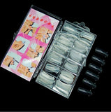 Set of false nails in a clear plastic case with a pink instruction sheet on a black background.