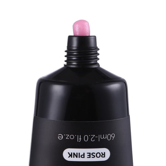 Black cosmetic bottle with pink cap on a white background