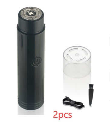 Black electric shaver with clear container and brush on a white background
