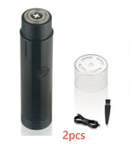 Black electric shaver with clear container and brush on a white background
